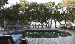 View over the swimming pool to the Indian Ocean at Tartaruga private villa on Vamizi Island.